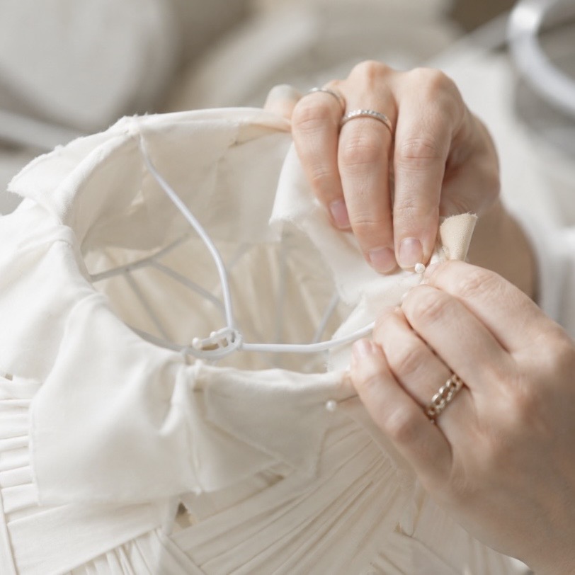 Pleating, fitting, and final hand assembly